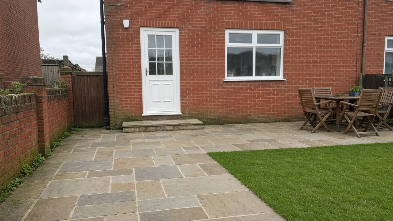 Example image: an Indian sandstone patio behind a red-brick house, with a step down from the back door and a lawn alongside